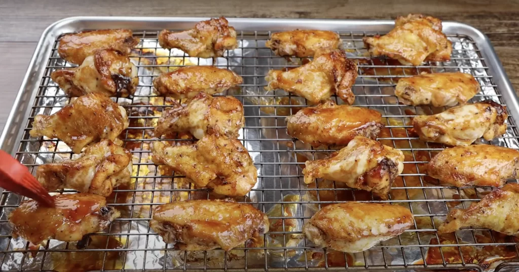 adding bbq sauce to wings